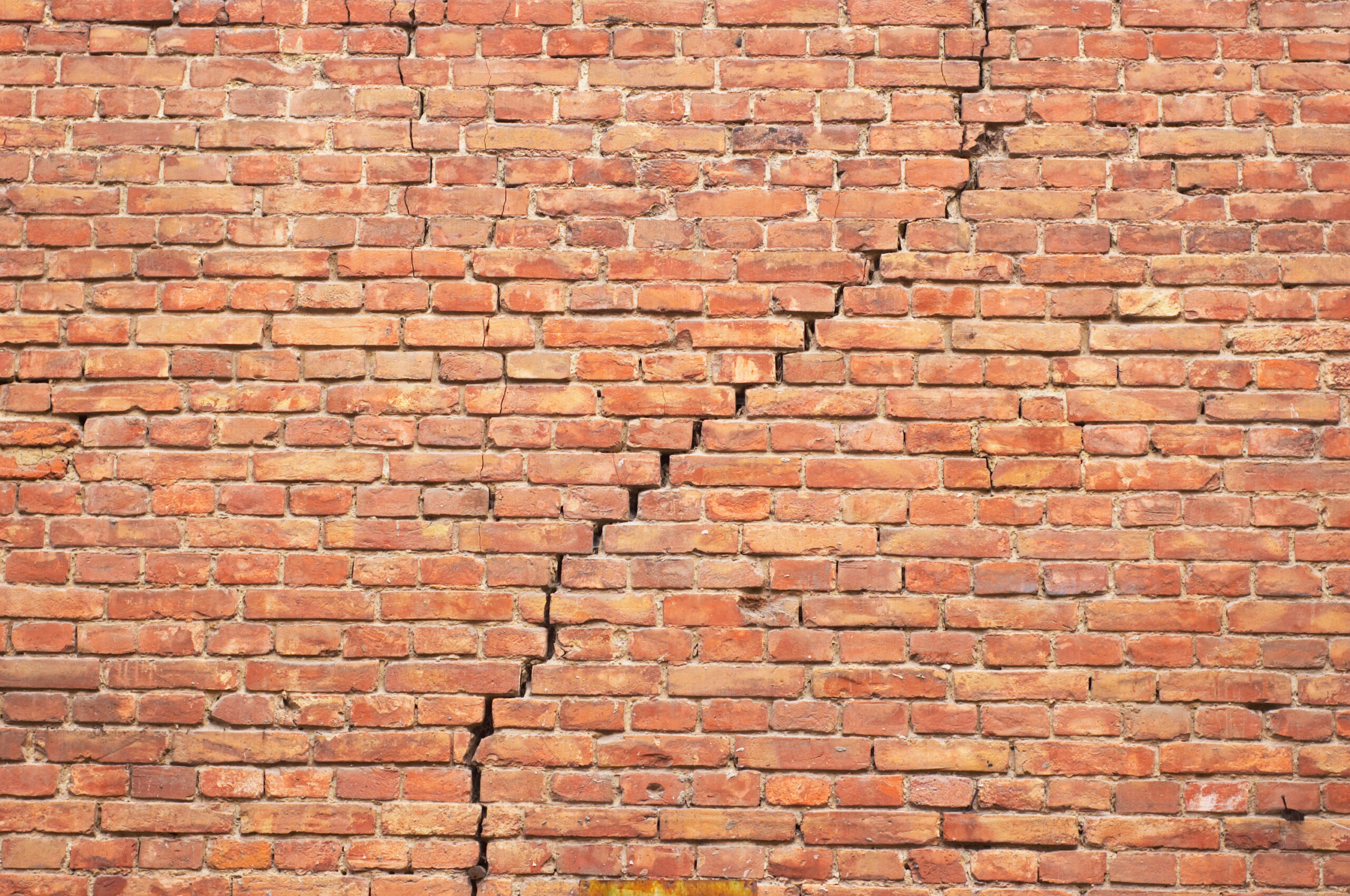 Restoration cracked red brick wall texture. grunge background.